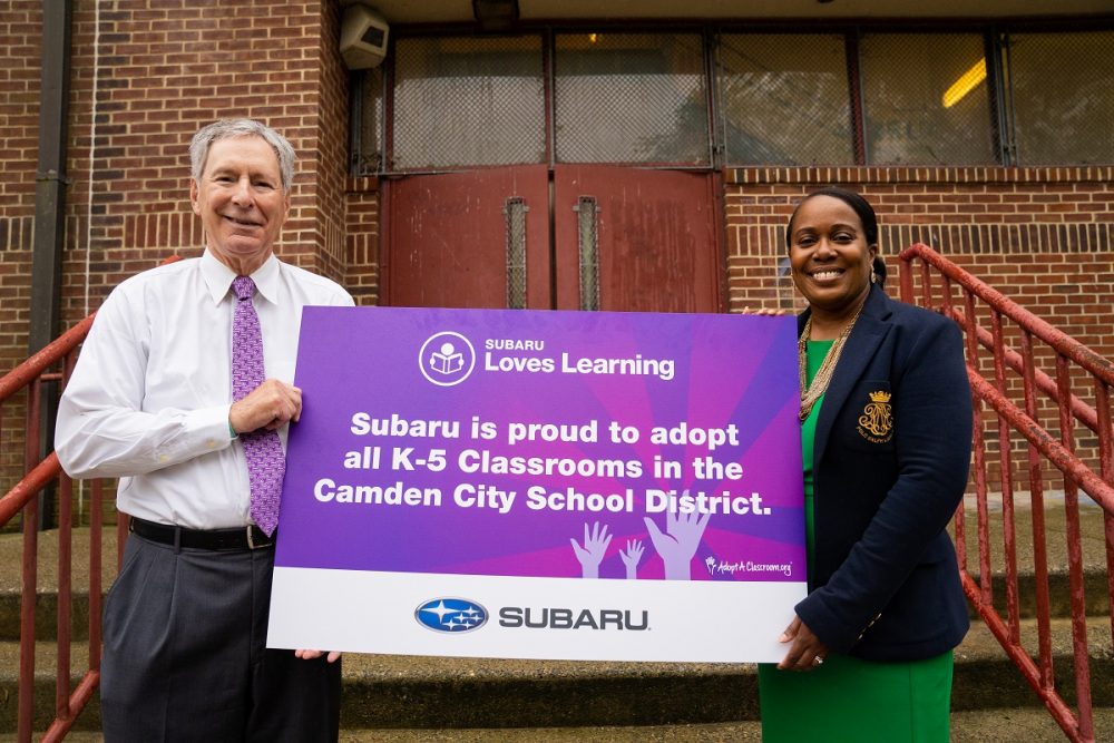 Subaru President CEO Thomas J Doll and Camden City School District Superintendent Katrina McCombs hold a Subaru Loves Learning sign together