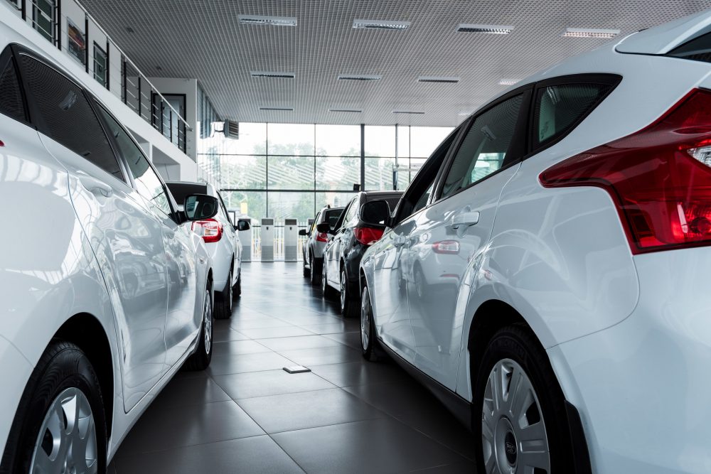 new cars on display inside a car dealership