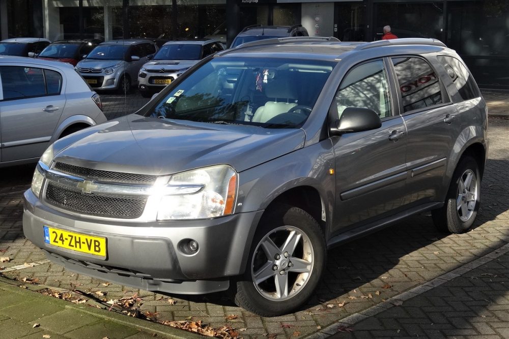 A silver gray 2008 Chevrolet Equinox is parked somewhere in Europe