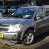 A silver gray 2008 Chevrolet Equinox is parked somewhere in Europe