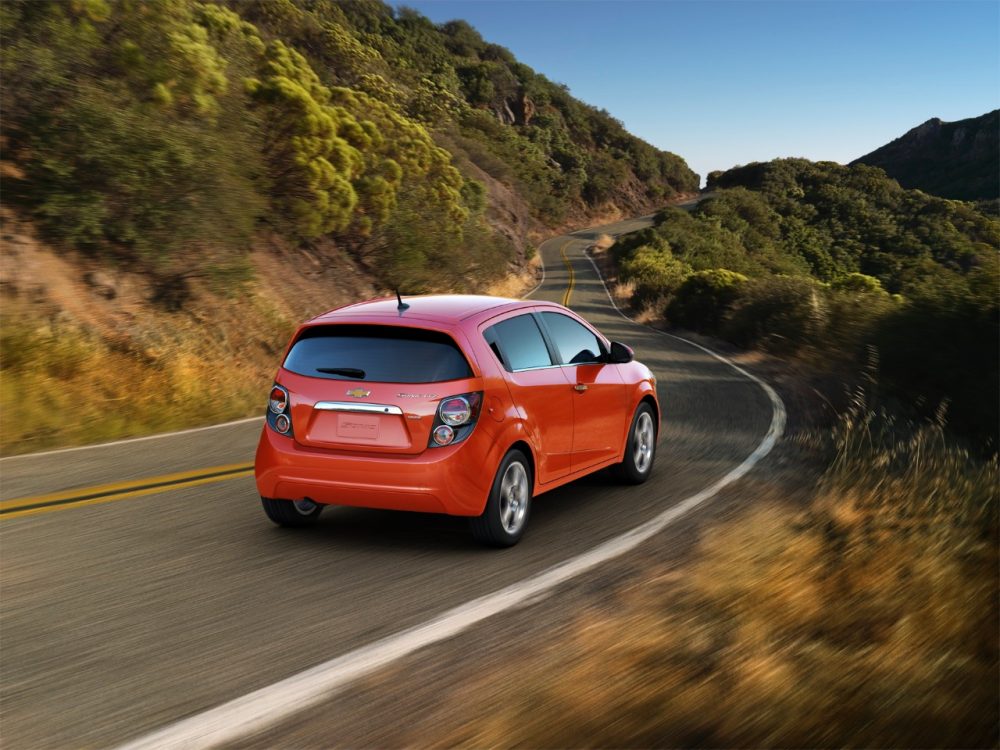 The back of the 2016 Chevrolet Sonic hatchback driving on the street