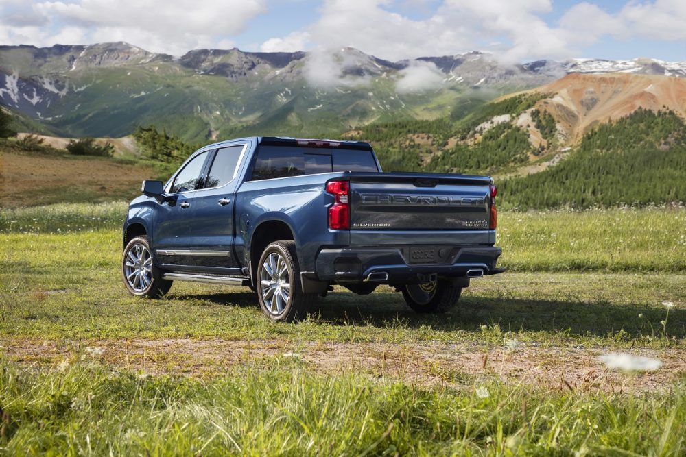 Rear side view of 2022 Chevrolet Silverado 1500 High Country with mountains in background