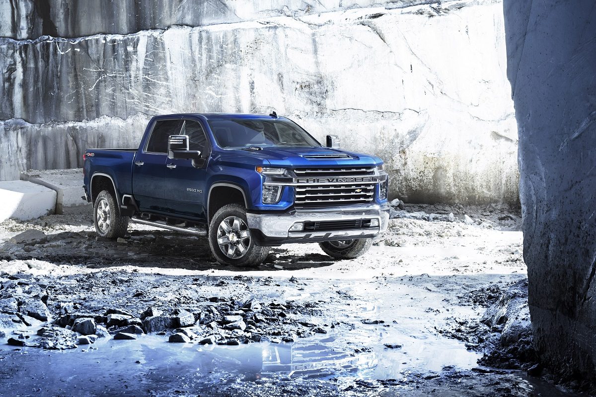 A blue 2022 Chevrolet Silverado 2500HD is parked in a rocky area