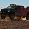 side view of a red 2022 Chevrolet Silverado on dusty desert roadZR2