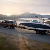 side view of a 2022 Chevrolet Tahoe RST towing a boat