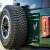 Rear mounted tire of a 2022 Ford Bronco four-door in Eruption Green