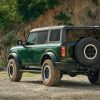 Rear left quarter angle of 2022 Ford Bronco four-door in Eruption Green