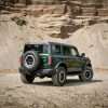 Rear quarter angle of 2022 Ford Bronco four-door in Eruption Green