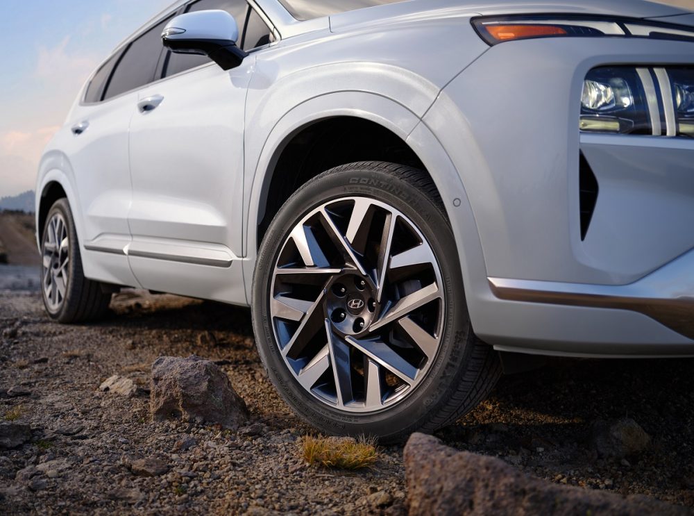 Close-up view of white 2022 Hyundai Santa Fe front wheel