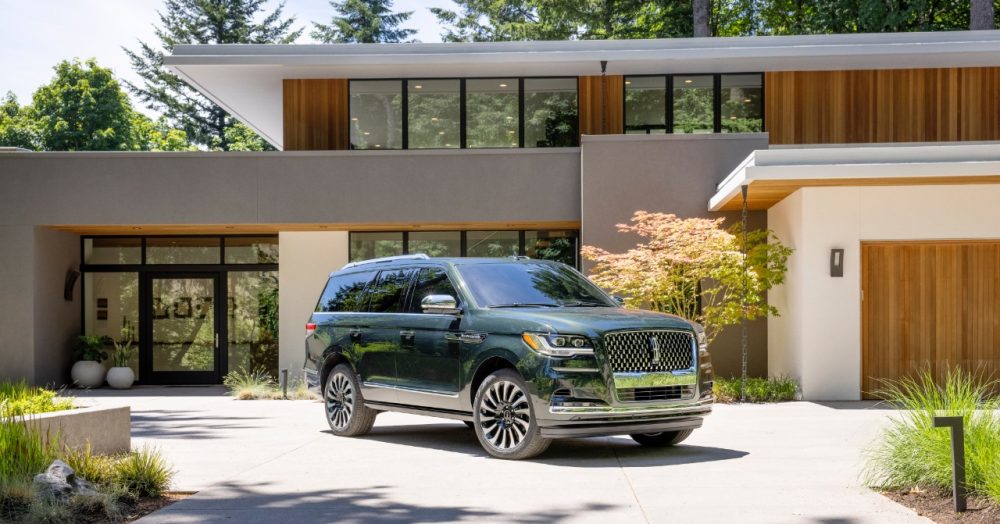 2022 Lincoln Navigator Black Label in Manhattan Green with Central Park theme in front of a ritzy house