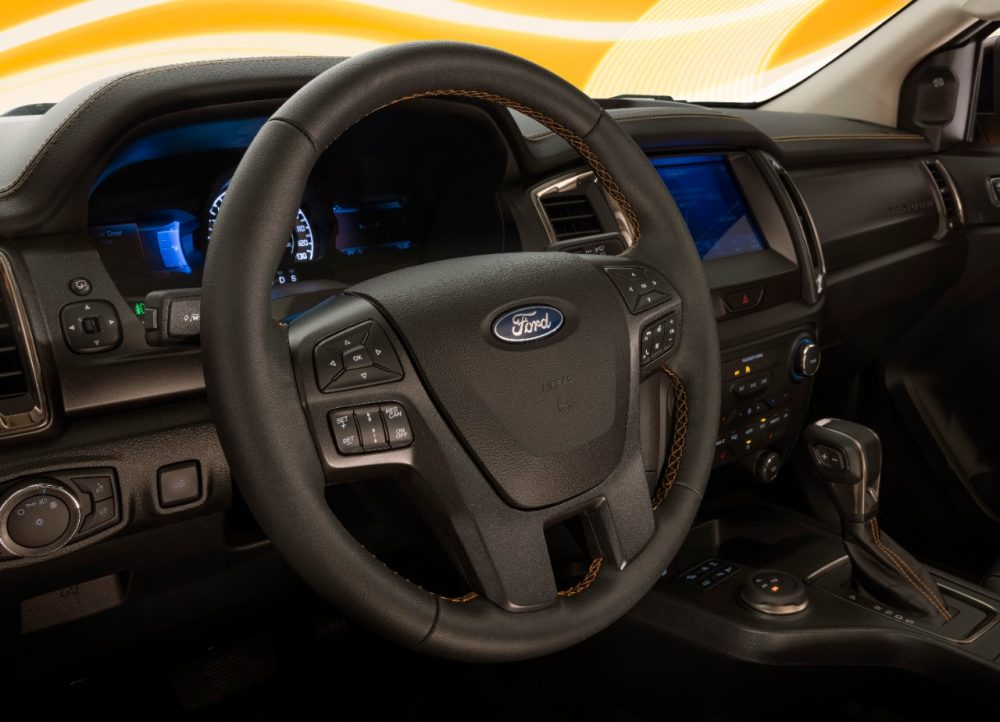 Leather-wrapped steering wheel of a 2022 Ranger Splash Package on a Cyber Orange Lariat CrewCab with optional FX4 Package