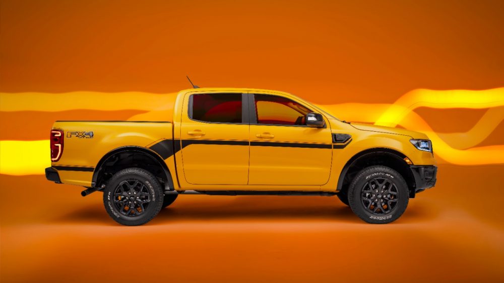 Side profile view of a 2022 Ranger Splash Package on a Cyber Orange Lariat CrewCab with optional FX4 Package