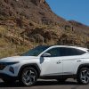 Side view of 2022 Hyundai Tucson Hybrid parked in front of hill