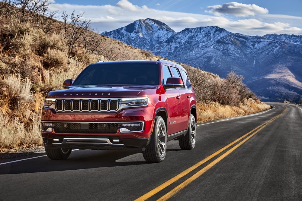 Front view of the 2022 Wagoneer on a highway in a mountain range