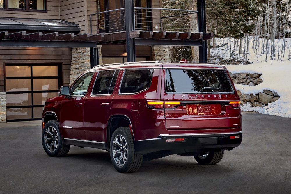 Rear view of the 2022 Wagoneer parked at a mountain home during winter