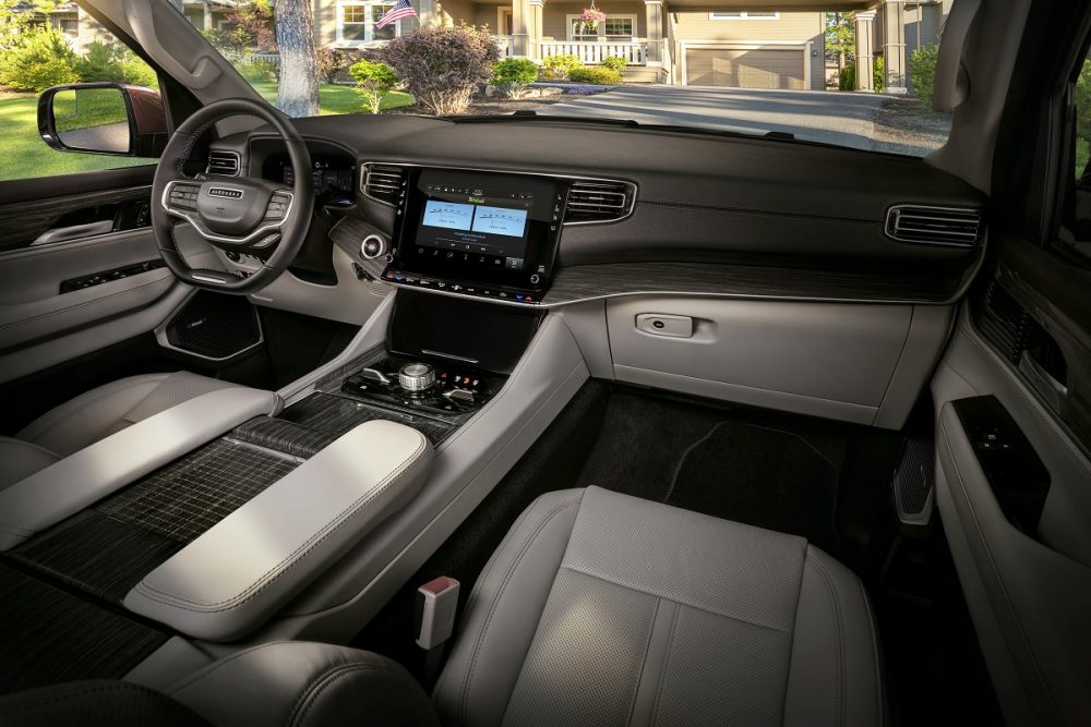 Interior view of the front seat area in the 2022 Wagoneer, showcasing the steering wheel and dash