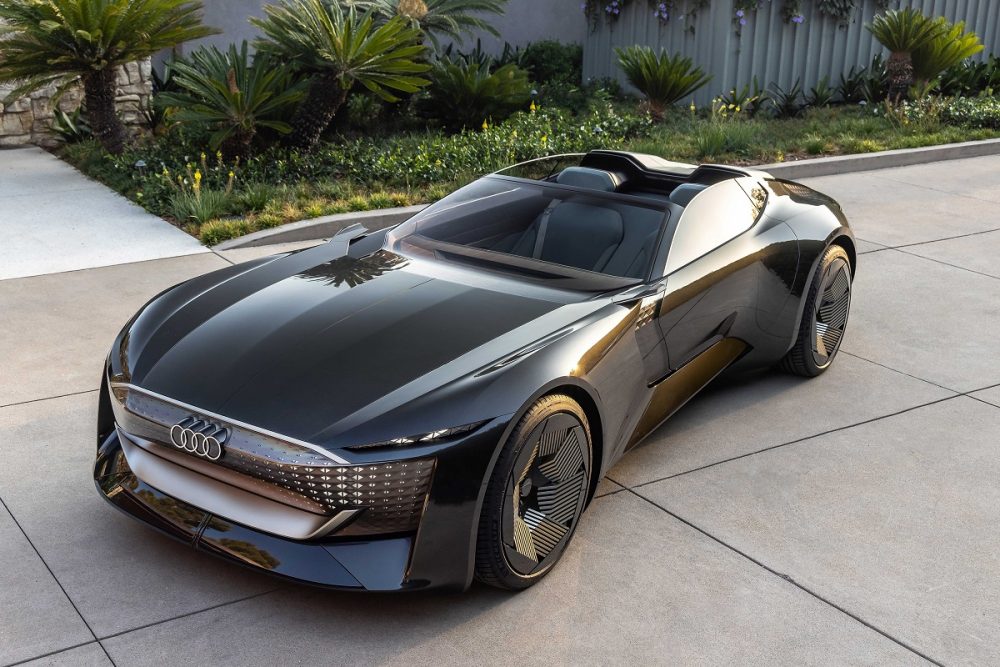 Front aerial view of a black Audi skysphere concept parked at sunset in a residential area