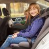 child sitting in a high-back booster seat inside a car