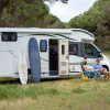 Couple in a field with motorhome