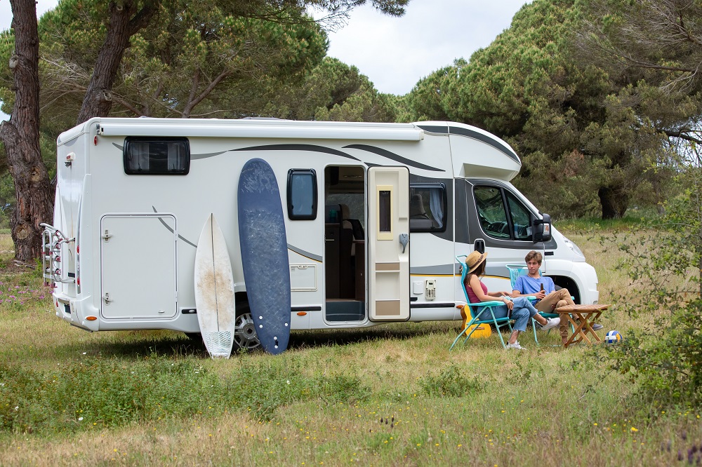 Couple in a field with motorhome