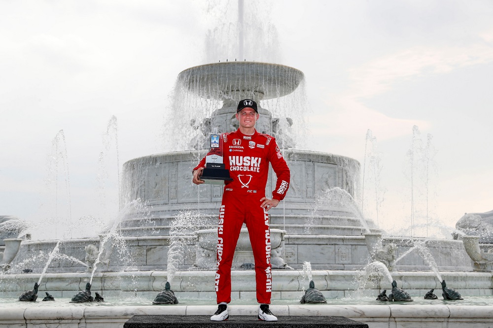 Ericsson with 2021 Detroit Grand Prix winners trophy in front of Belle Isle Foundation