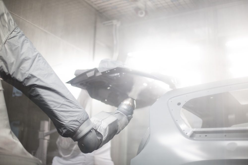 The back of a Chrysler Pacifica being sprayed in a paint booth at the Windsor Assembly Plant 