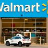 A self-driving Ford Escape Hybrid parked in front of a Walmart