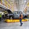 Workers inspect a pre-production 2022 Ford F-150 Lighting at the Ford Rouge Electric Vehicle Center