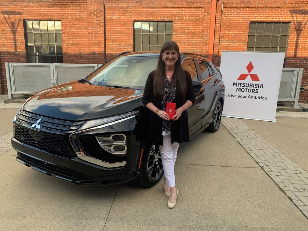 Mel Taylor standing in front of her 2022 Eclipse Cross  