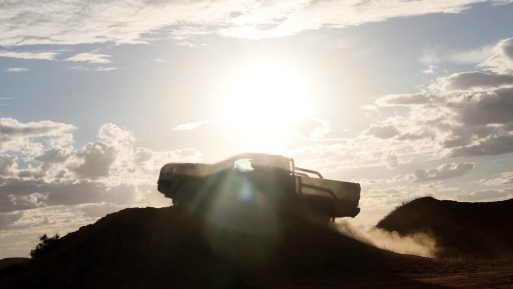 The silhouette of a camouflaged next-generation Ford Ranger cresting over a hill