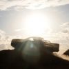 The silhouette of a camouflaged next-generation Ford Ranger cresting over a hill