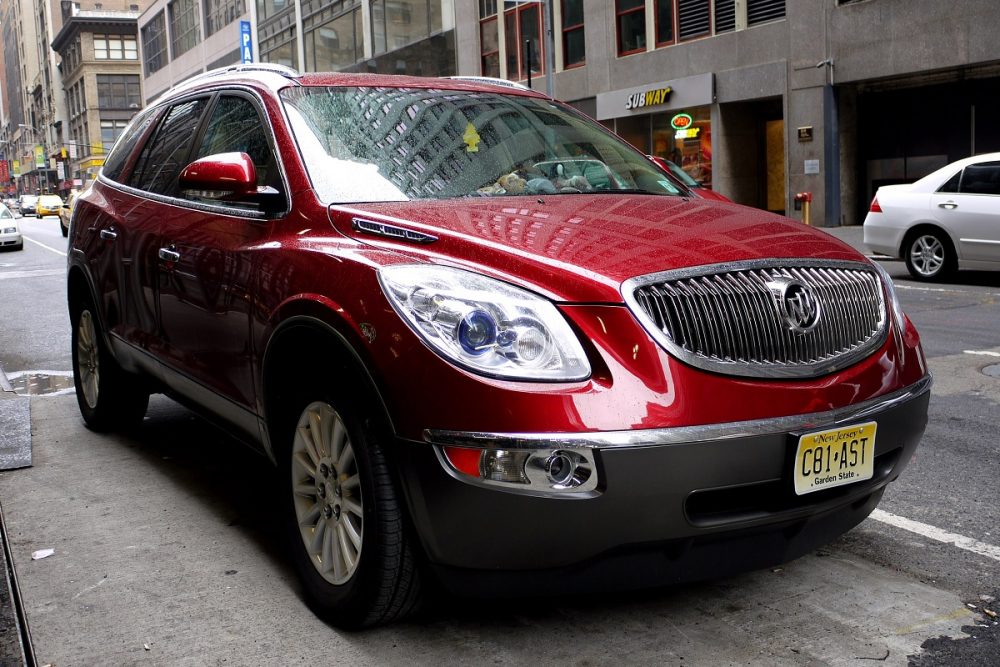 Front view of a red 2010 Buick Enclave parked on a city street