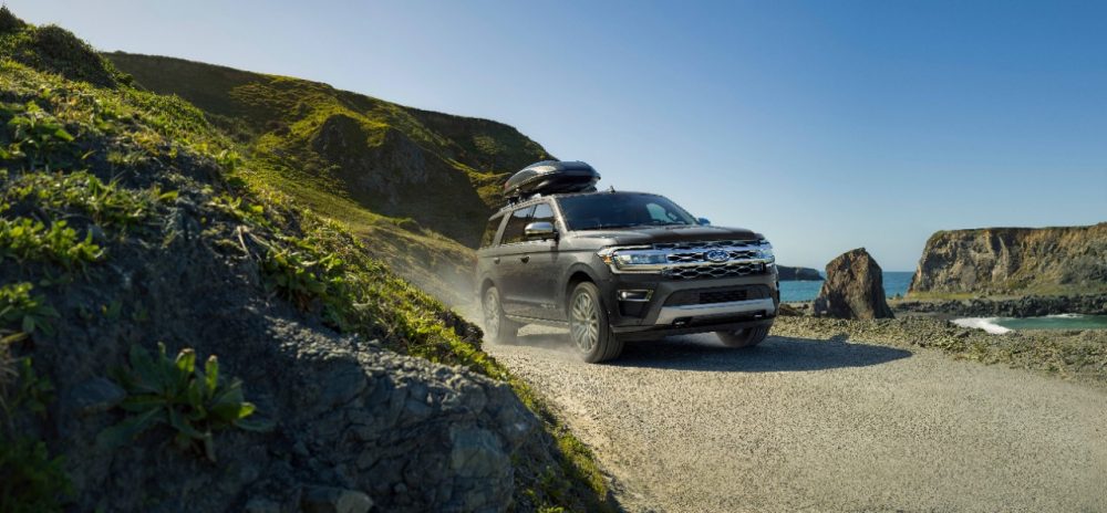 2022 Ford Expedition Platinum in Dark Matter going down a trail