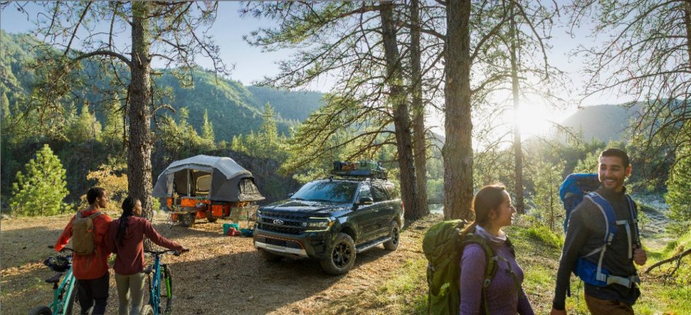 2022 Ford Expedition Timberline in a clearing with campers