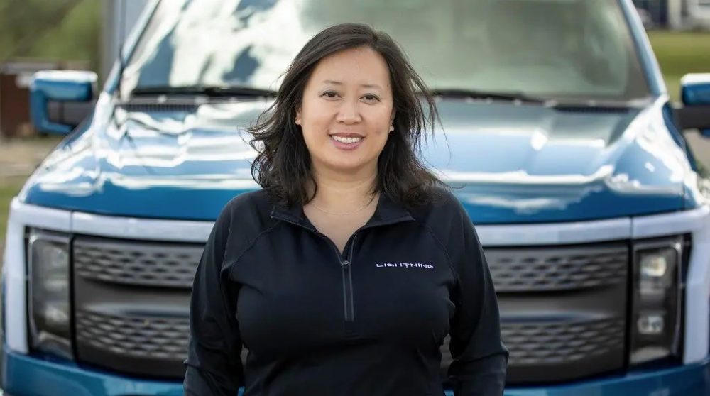 2022 Ford F-150 Lightning Chief Engineer Linda Zhang standing in front of a Ford F-150 Lightning