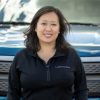 2022 Ford F-150 Lightning Chief Engineer Linda Zhang standing in front of a Ford F-150 Lightning