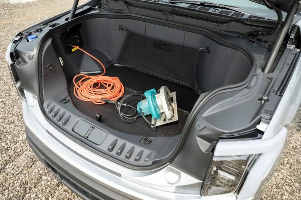 2022 Ford F-150 Lightning Mega Power Frunk with saw plugged into one of four 12-volt AC outlets