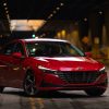 Front side view of red 2022 Hyundai Elantra parked in shadows