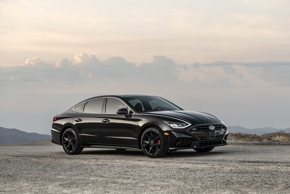 Front side view of 2022 Hyundai Sonata N Line Night Edition with mountains and clouds in background 