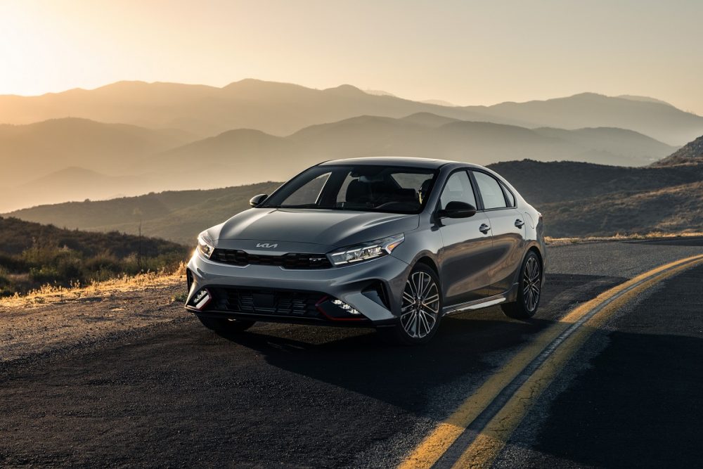 Exterior front view of a silver 2022 Kia Forte parked at sunset