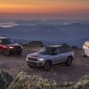 The 2022 Jeep Grand Cherokee Trailhawk, Trailhawk 4xe, and Summit Reserve 4xe overlooking mountains