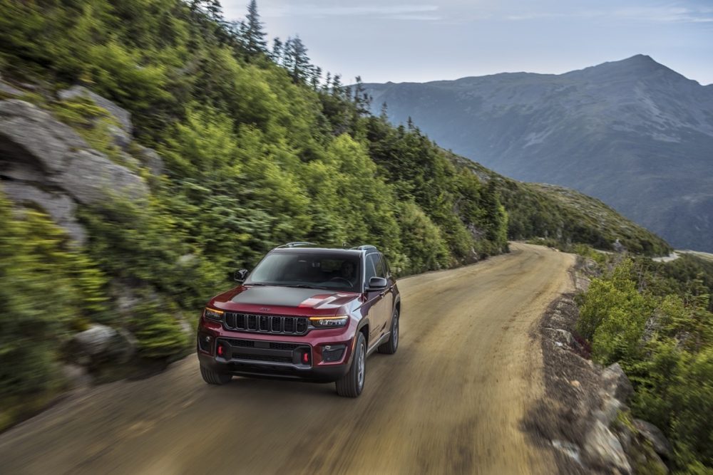 The 2022 Jeep Grand Cherokee Trailhawk driving on a sandy road