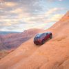 The 2022 Jeep Grand Cherokee Trailhawk driving up a hill