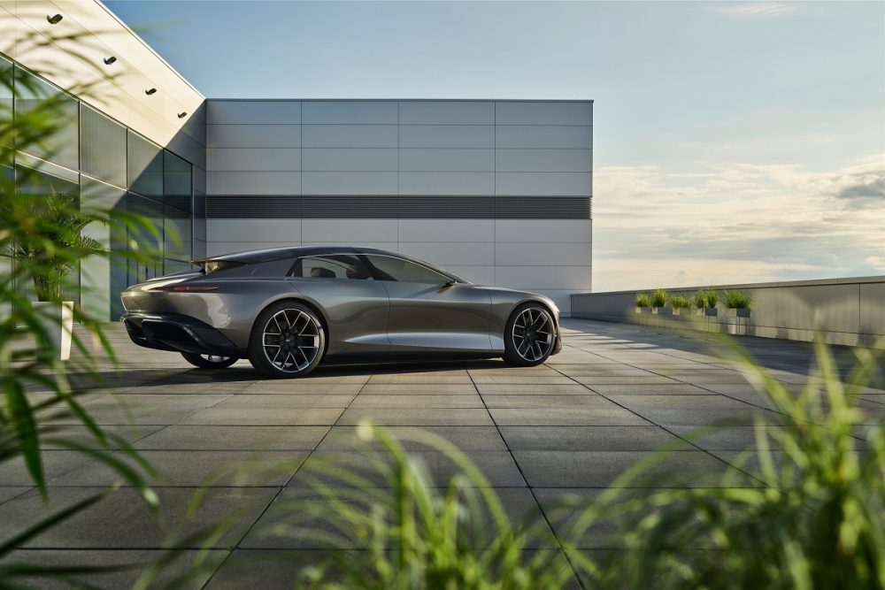 Side view of the Audi grandsphere concept parked next to a building at sunset