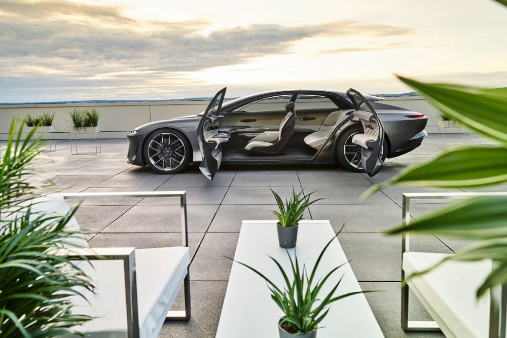 Side view of the Audi grandsphere concept with its doors open, parked at sunset