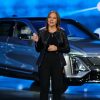 GM Chair and CEO Mary Barra gesturing in front of a Cadillac LYRIQ EV