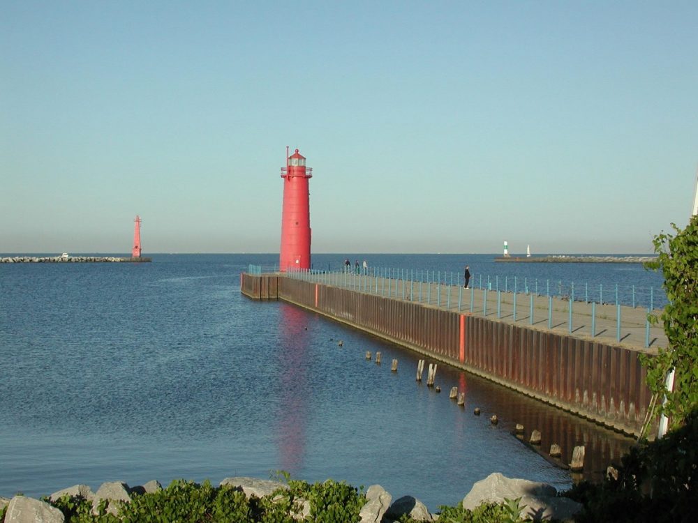 A red lighthouse on the shore of Lake Michigan in Muskegon, Michigan