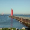 A red lighthouse on the shore of Lake Michigan in Muskegon, Michigan