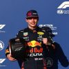 Verstappen gives a thumbs up with pole position trophy