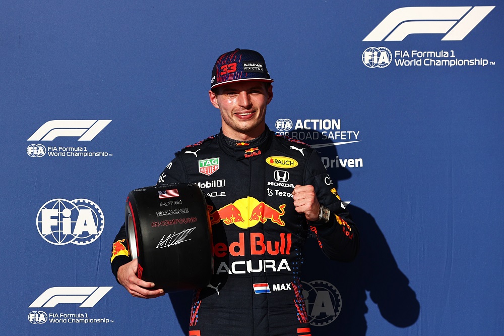 Verstappen gives a thumbs up with pole position trophy